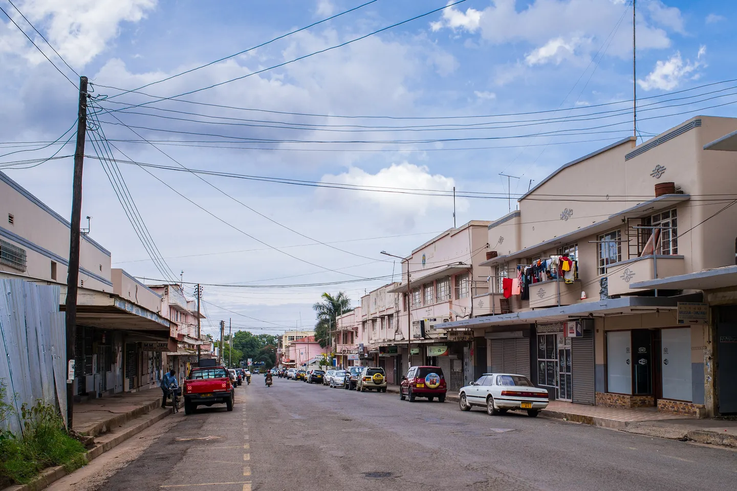 A street of shops and parked cars in Arusha.
