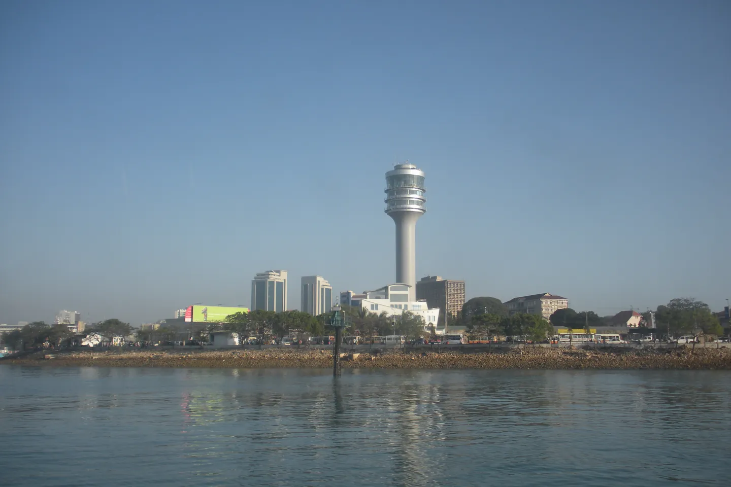 The Dar es Salaam waterfront with city buildings across the water.